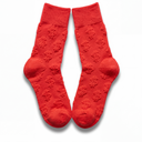 Flat lay of red Money Socks crew socks standing upright, displaying the embossed 3D dollar-sign pattern down each leg